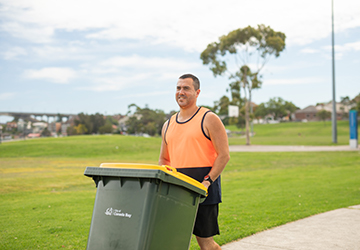 Image of man collecting recycling bin