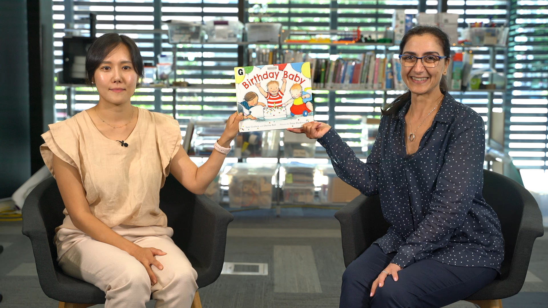 Julie and Liz holding a picture book