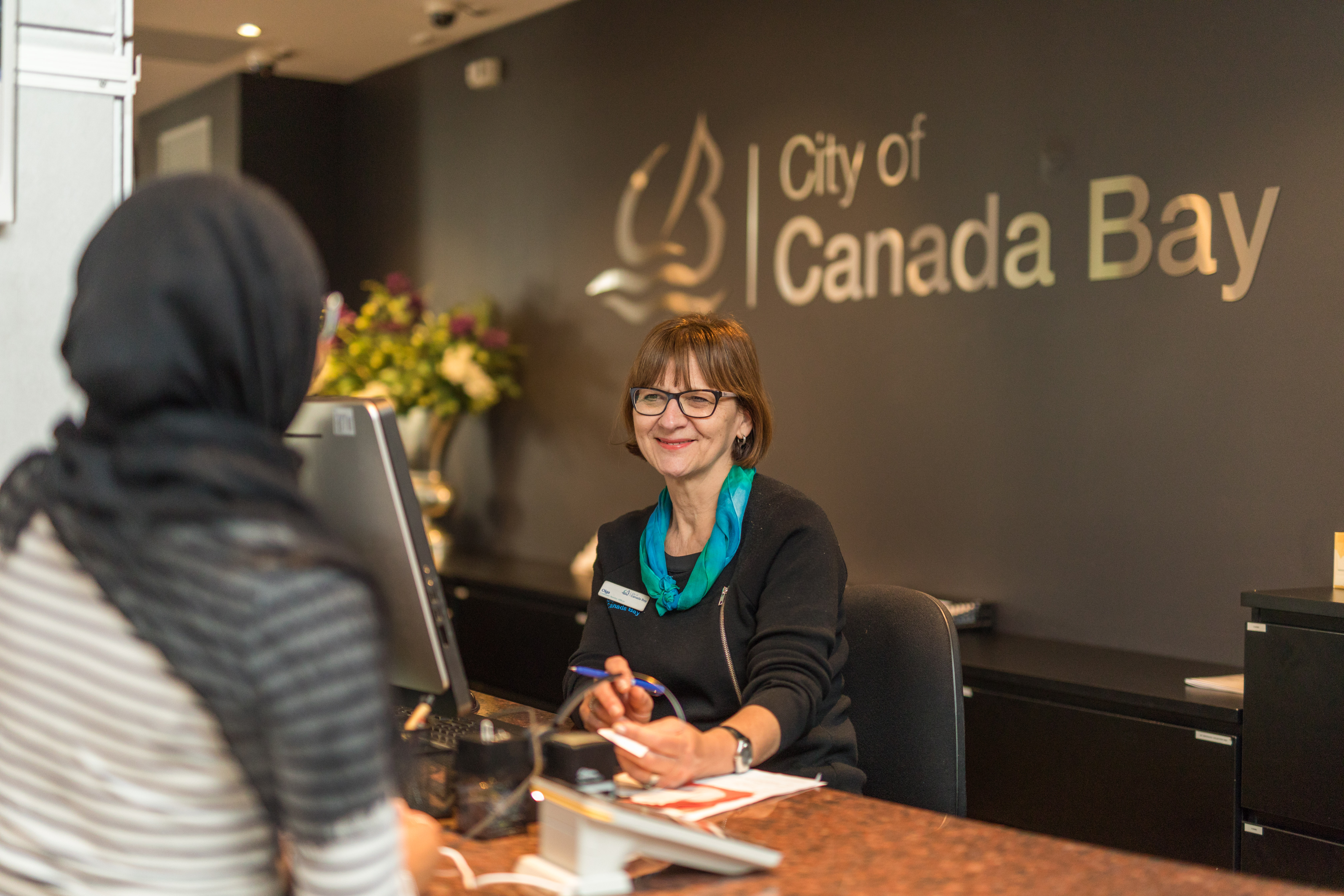 Customer Service staff talking to a resident