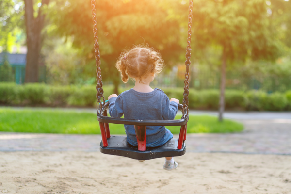 Little girl on swing