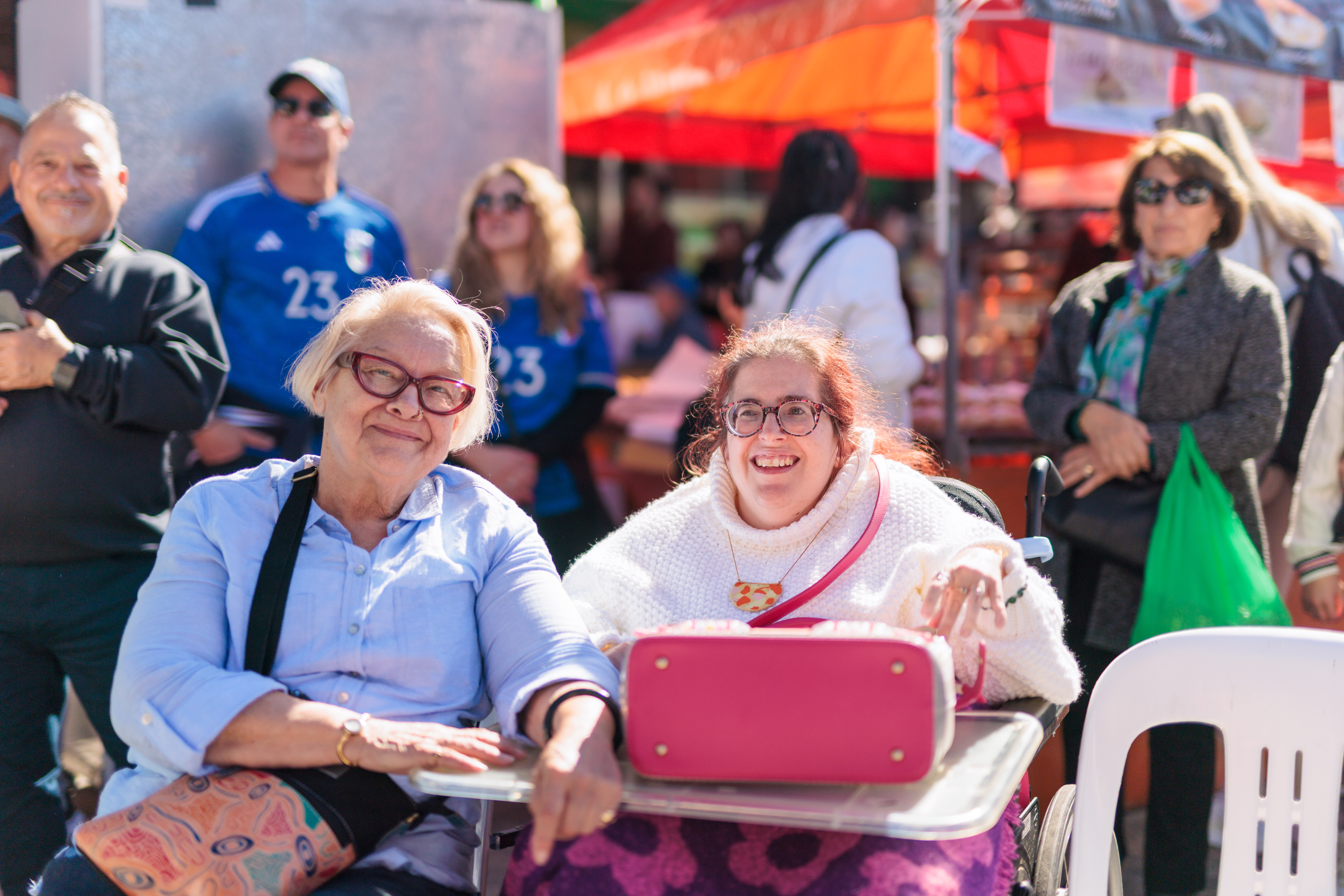 Older woman and woman in wheelchair smiling