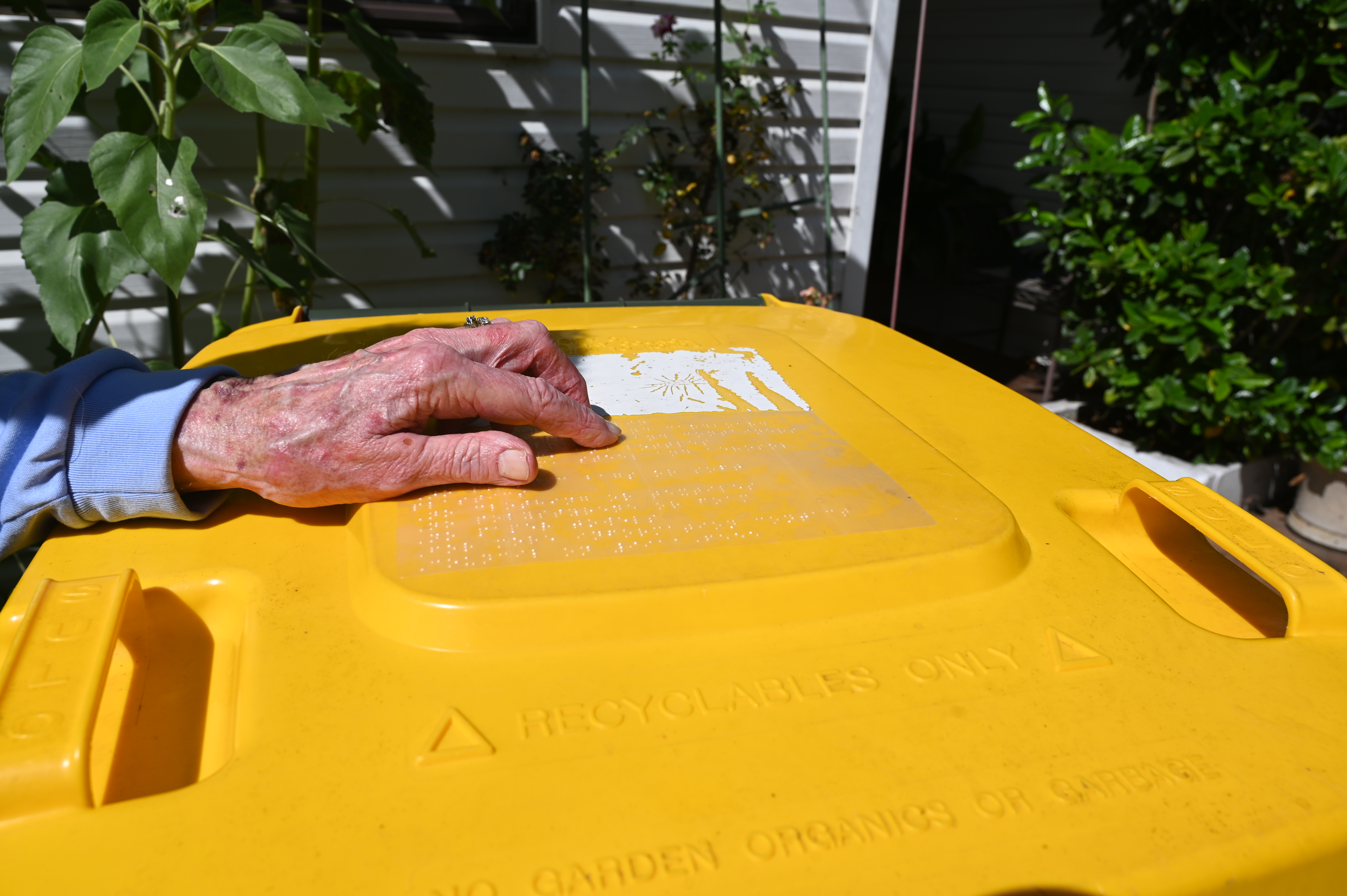 Recycling bin with braille bin label