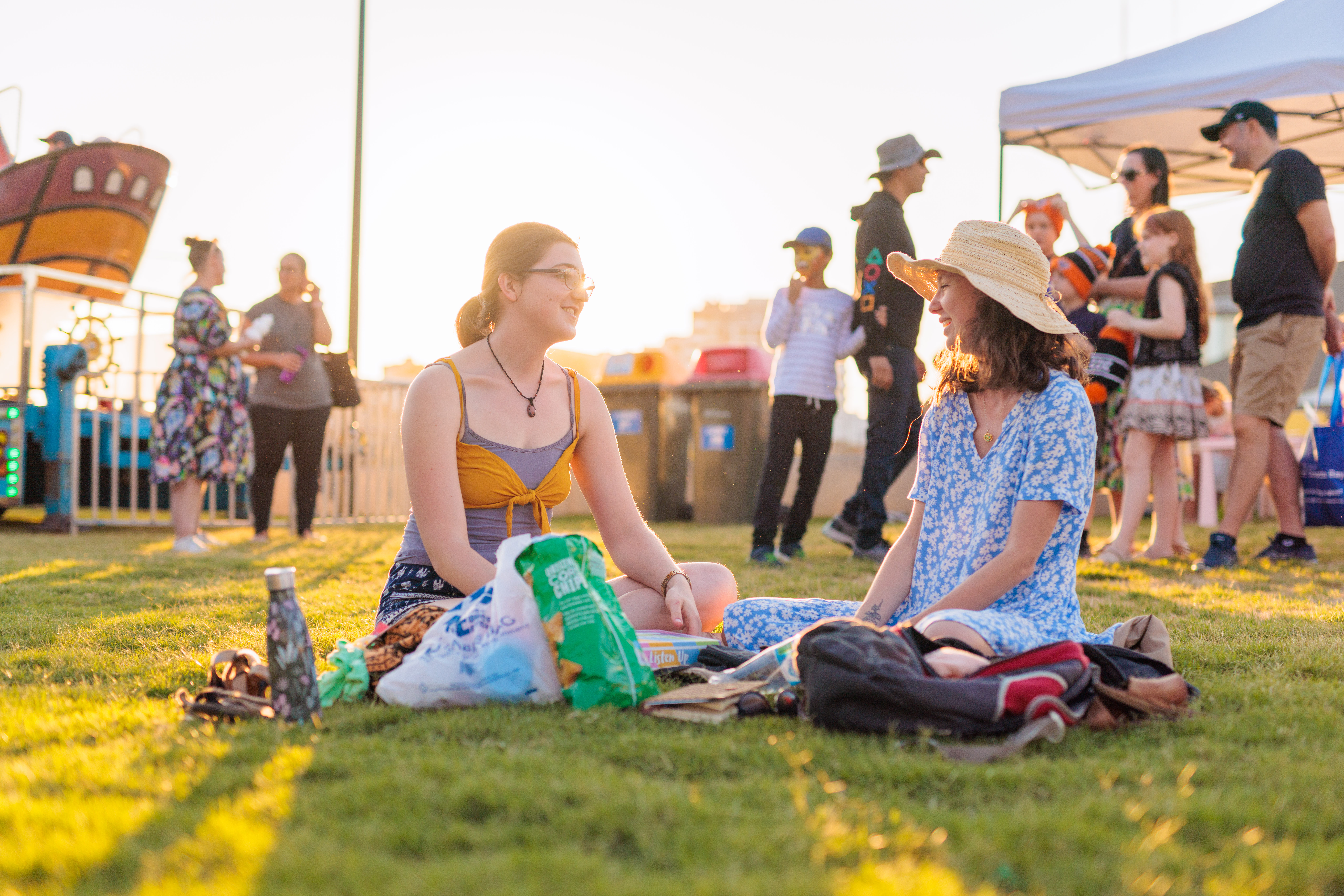 Two women chatting on the grass