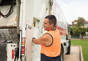 Image of man with waste collection truck