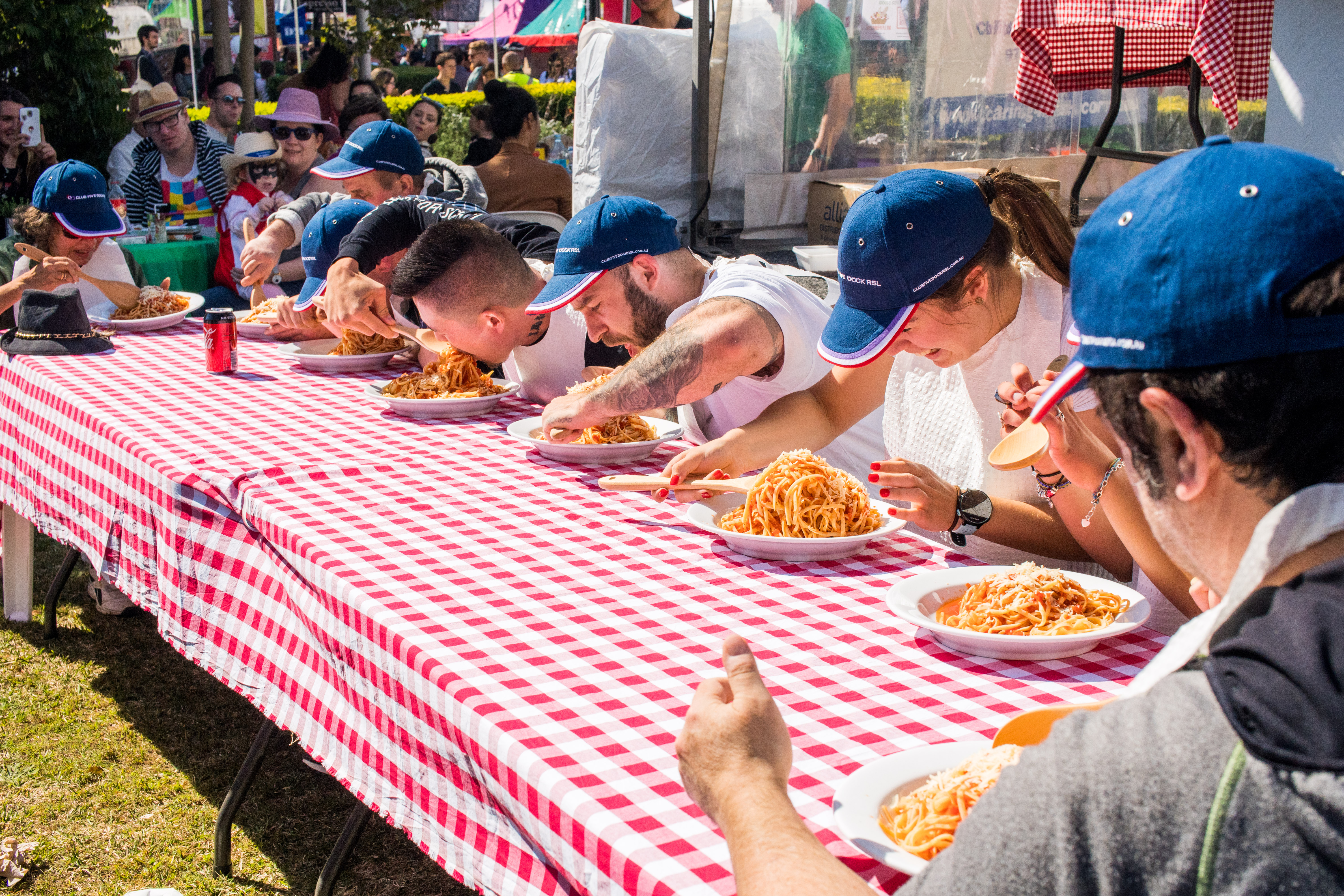 people eating spaghetti at competition