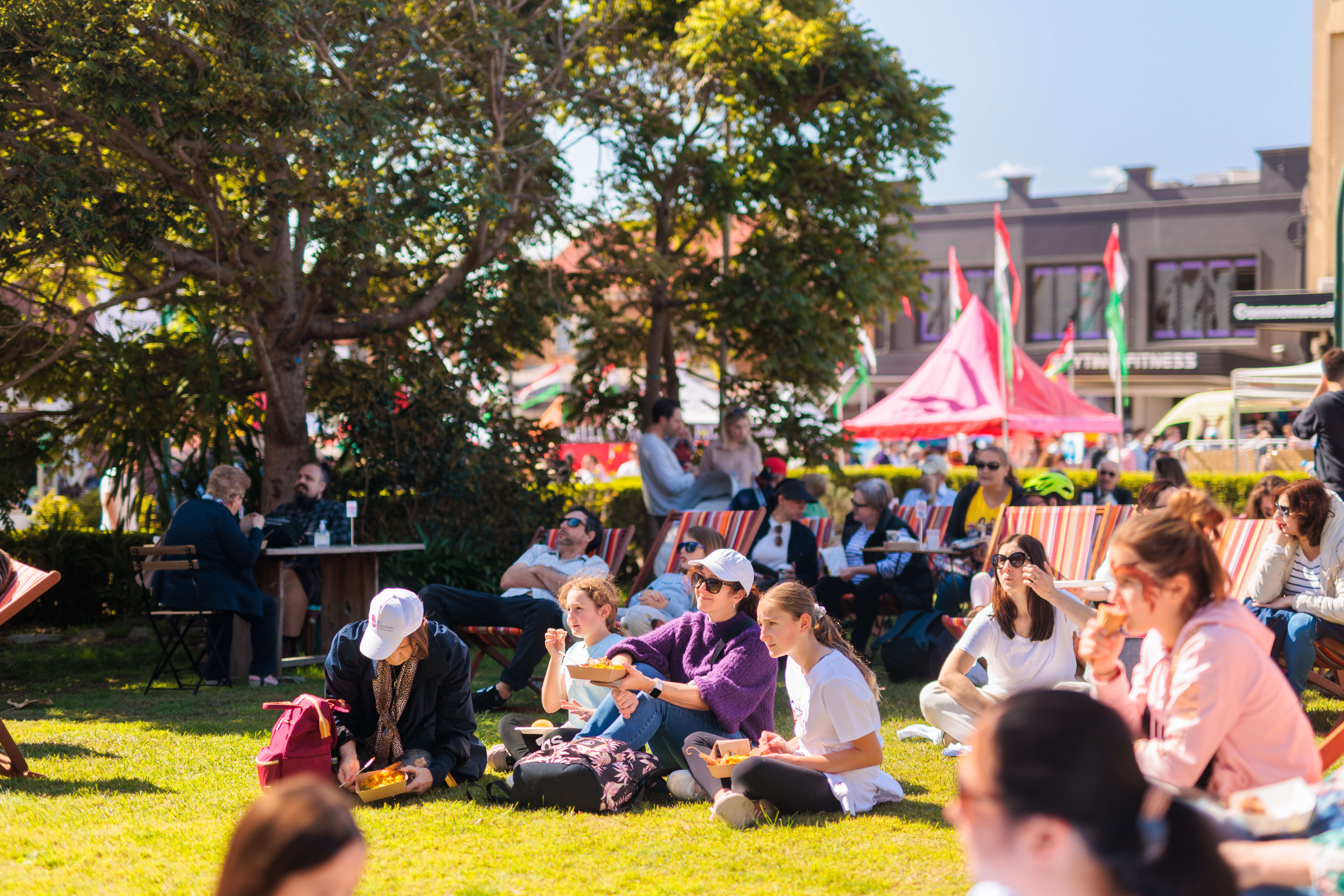 people seating on the grass of the church ground