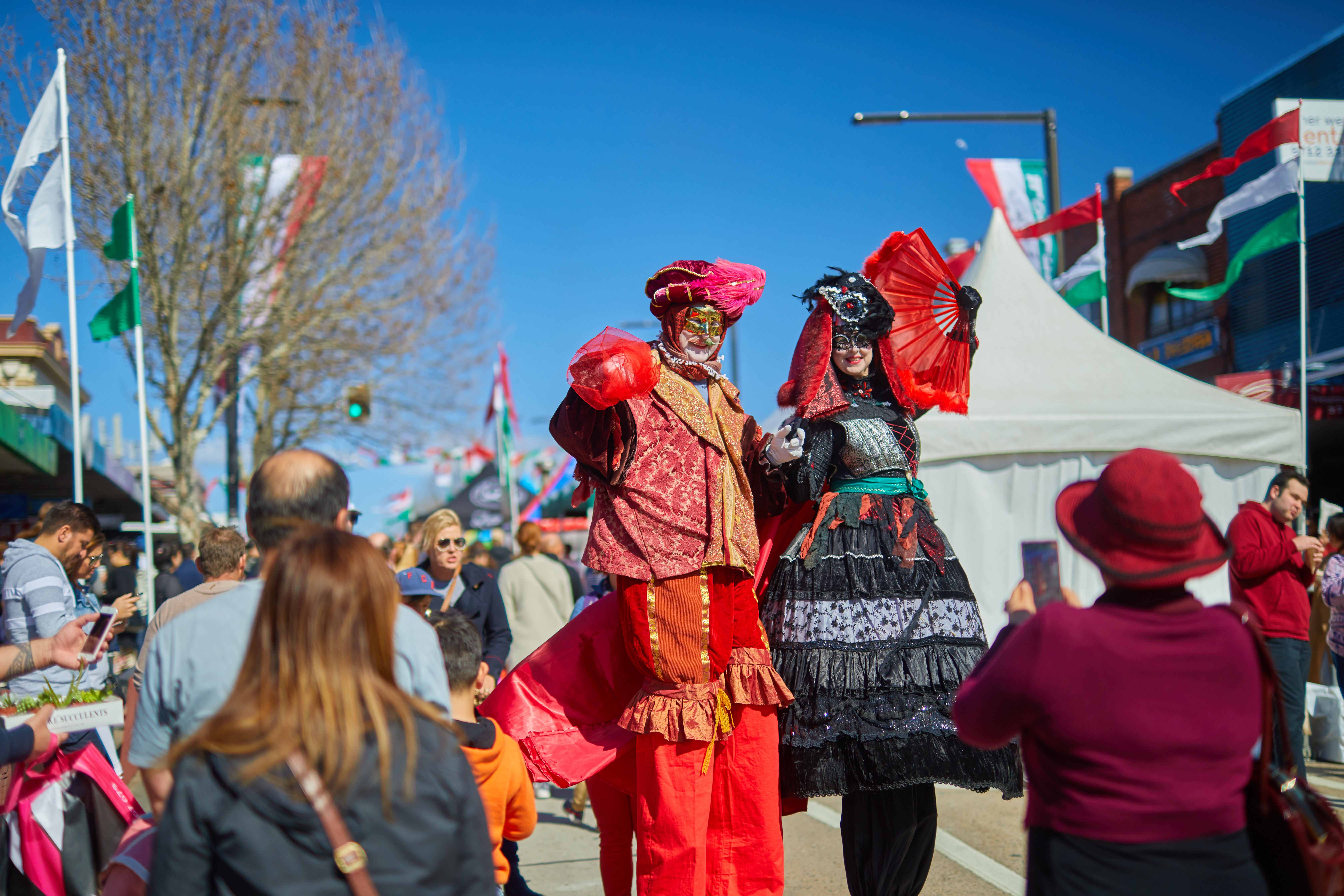 people taking photos of roving performers