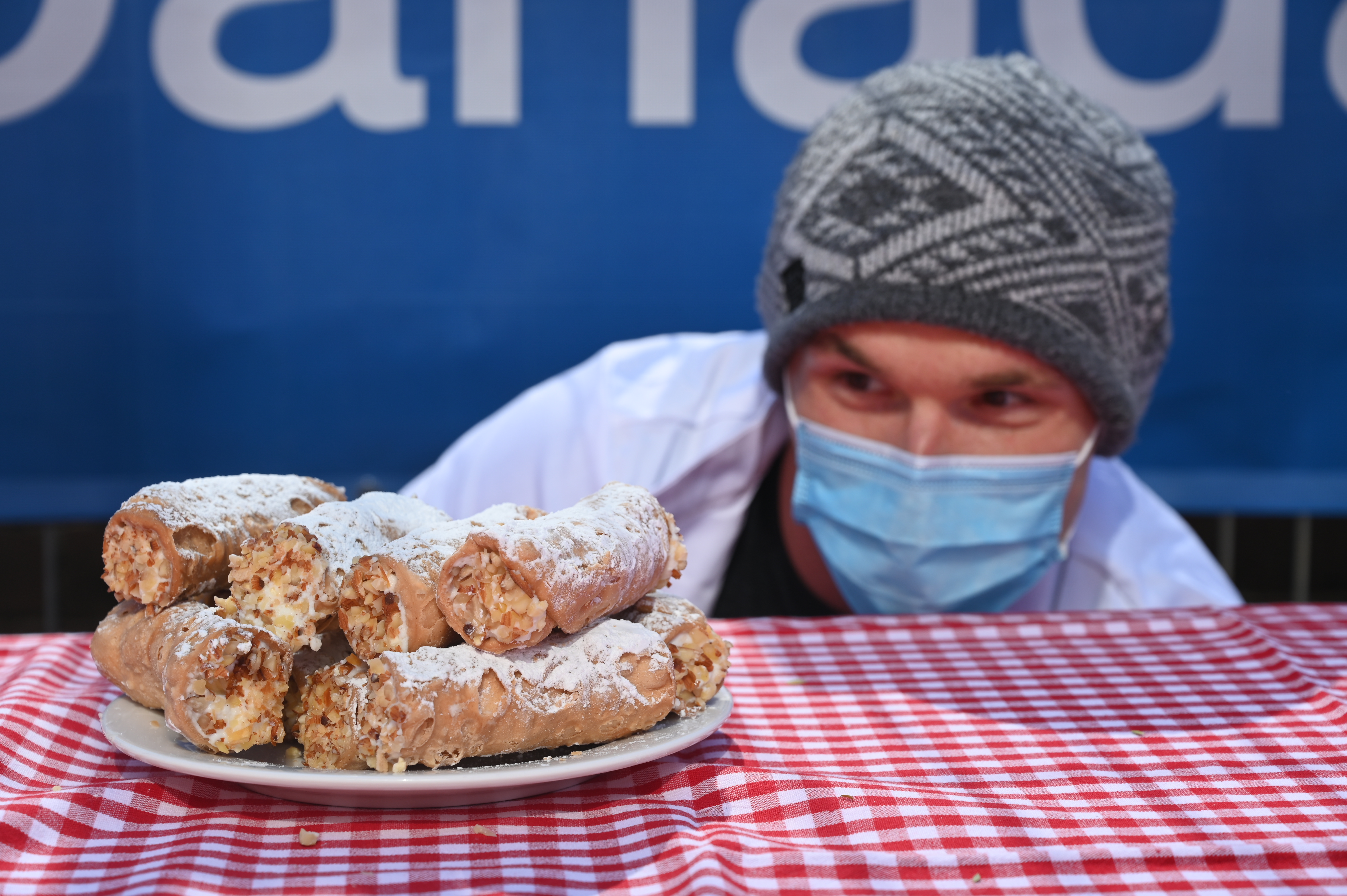 man staring at plate of cannoli
