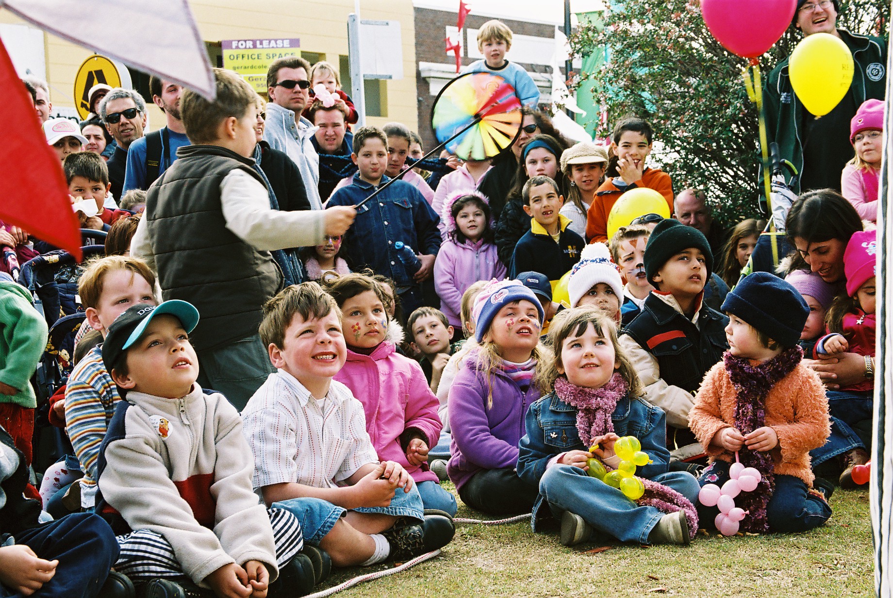 crowd of kids sitting down and smiling