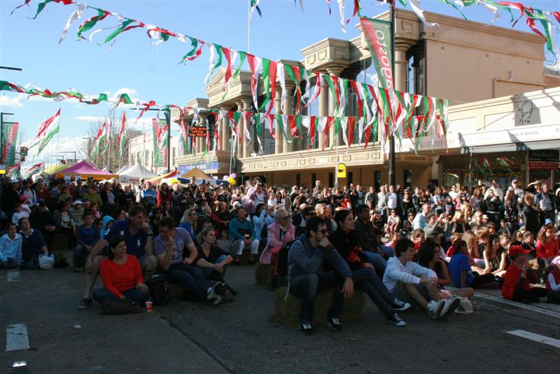 Crowd seating down on street