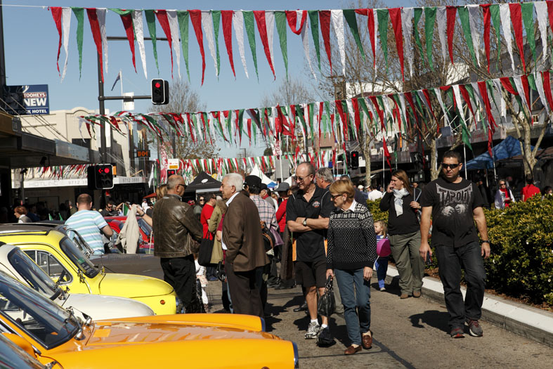 crowd walking past car display