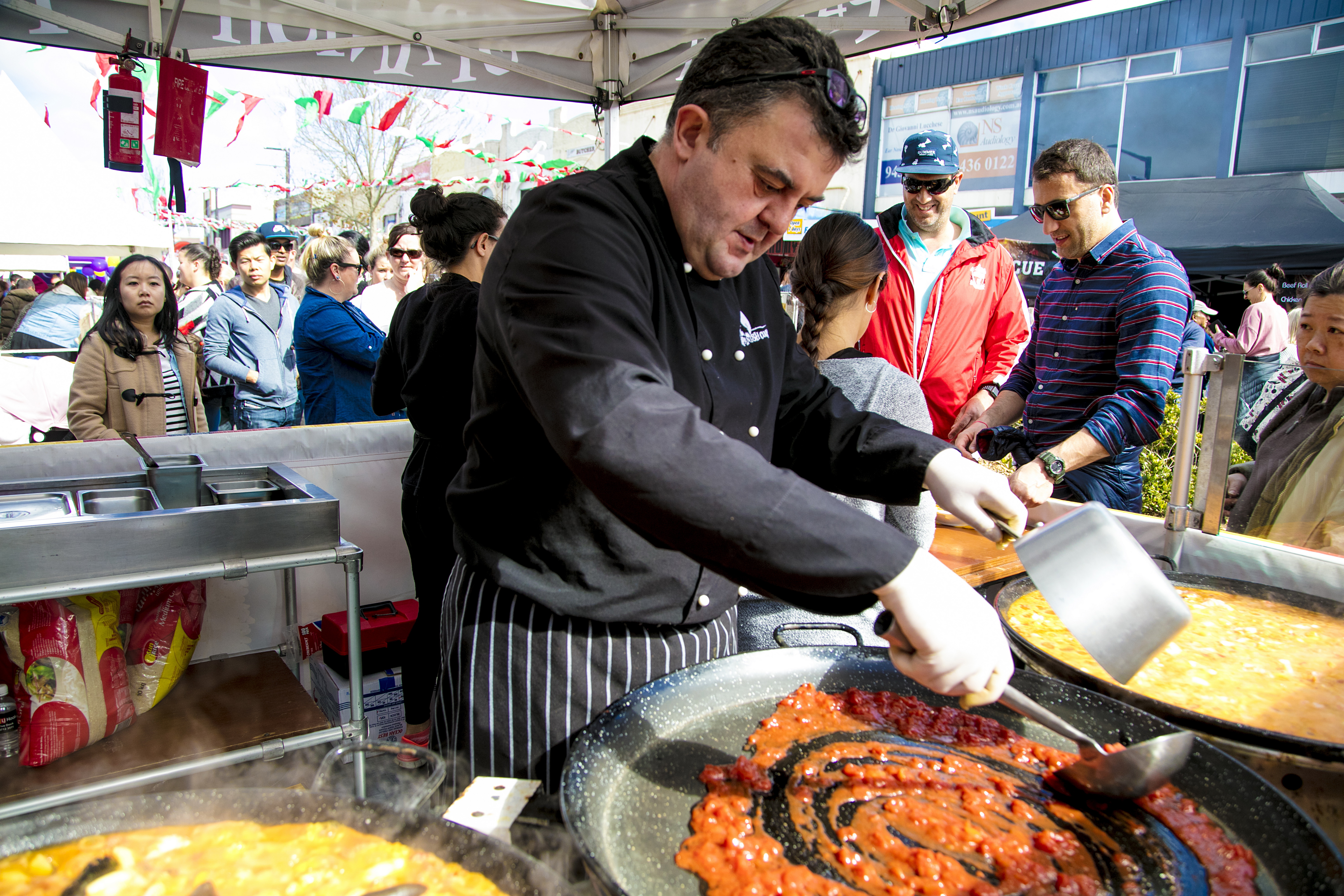 man cooking food at stall