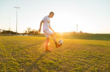 Image of young man playing soccer