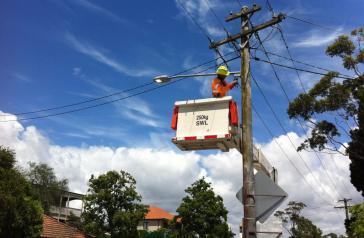 Image of worker replacing street light