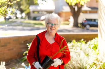 Image of local resident with native plant
