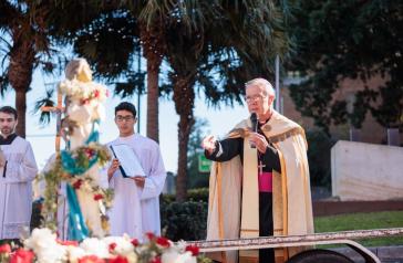 Bishop Daniel Meagher and a statue of Mary.