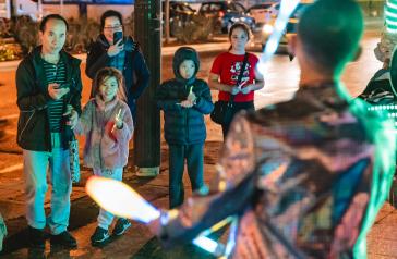 A crowd watching a juggler perform