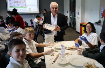 Mayor Michael Megna with Concord High School students at Youth Week workshop making dumplings.